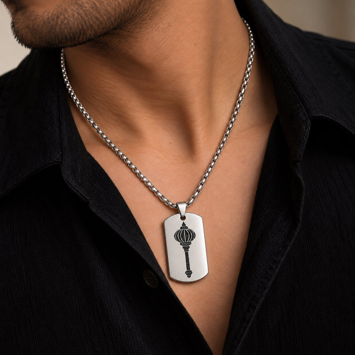 Man wearing silver stainless steel Hanuman gada tag pendant on silver chain