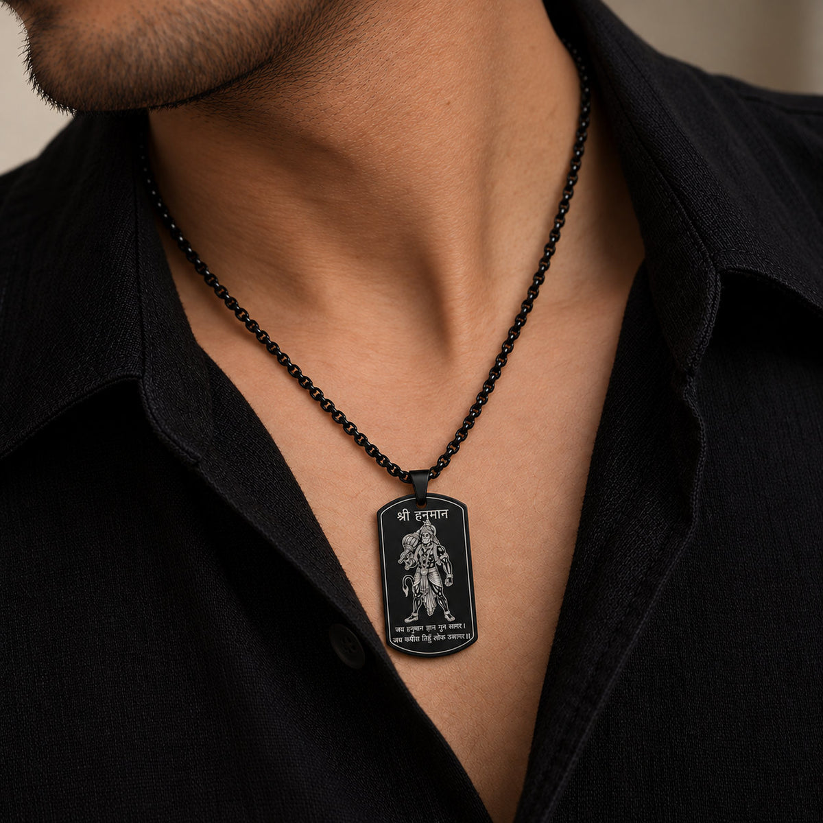 Man wearing black Shri Hanuman engraved tag pendant over black shirt