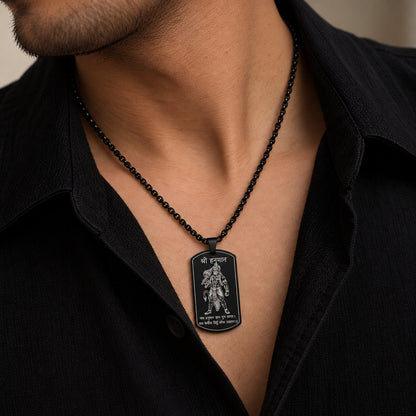 Man wearing black Shri Hanuman engraved tag pendant over black shirt