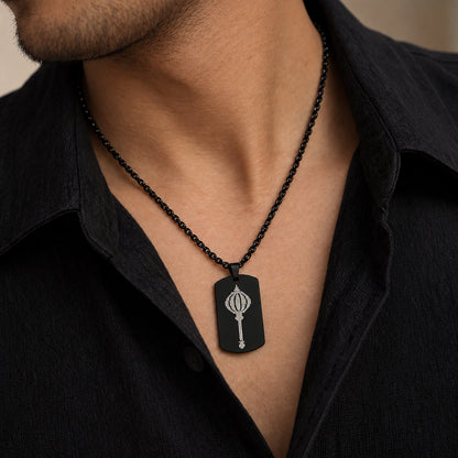 Man wearing black Hanuman gada tag pendant over black shirt