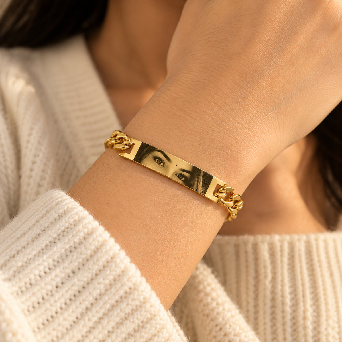 Gold personalized eye bracelet worn on a woman's wrist