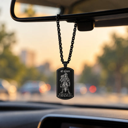 Black Hanuman tag pendant hanging from car rear-view mirror