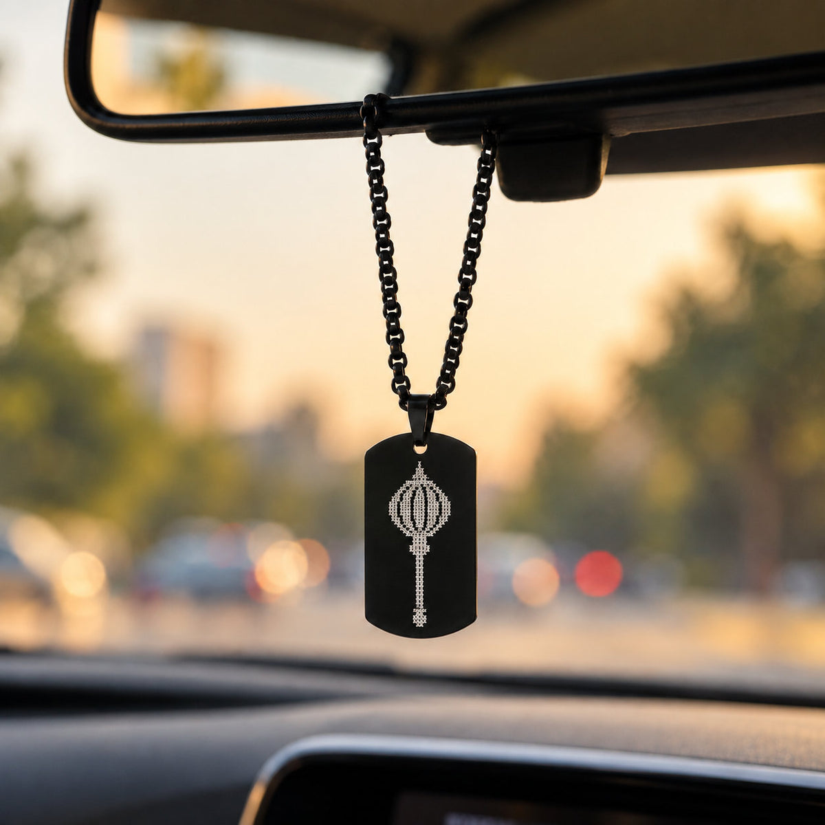 Black Hanuman gada tag pendant hanging from car rear-view mirror