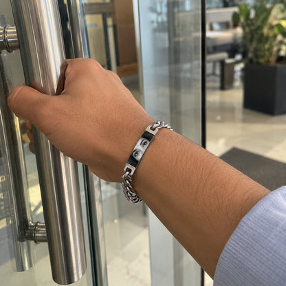 Silver personalized eye bracelet worn on a man's wrist